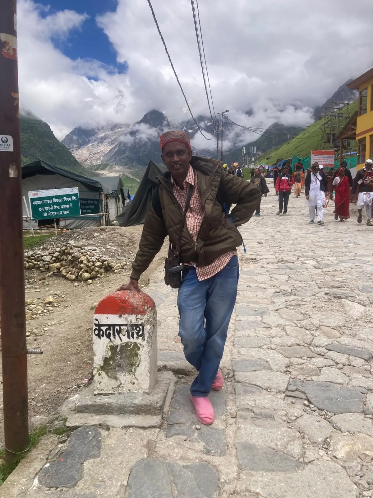 A group of travellers at a high Himalayan village sign